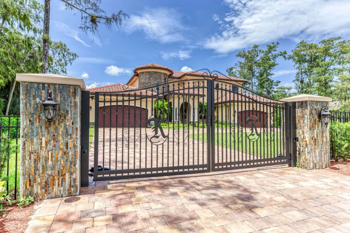 Ronin Development luxury home entrance with custom gates and stone columns