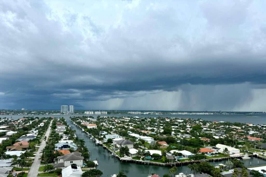Dark storm clouds gather over a luxury waterfront neighborhood in South Florida, highlighting the importance of hurricane-resistant home construction, resilient engineering, and coastal living.