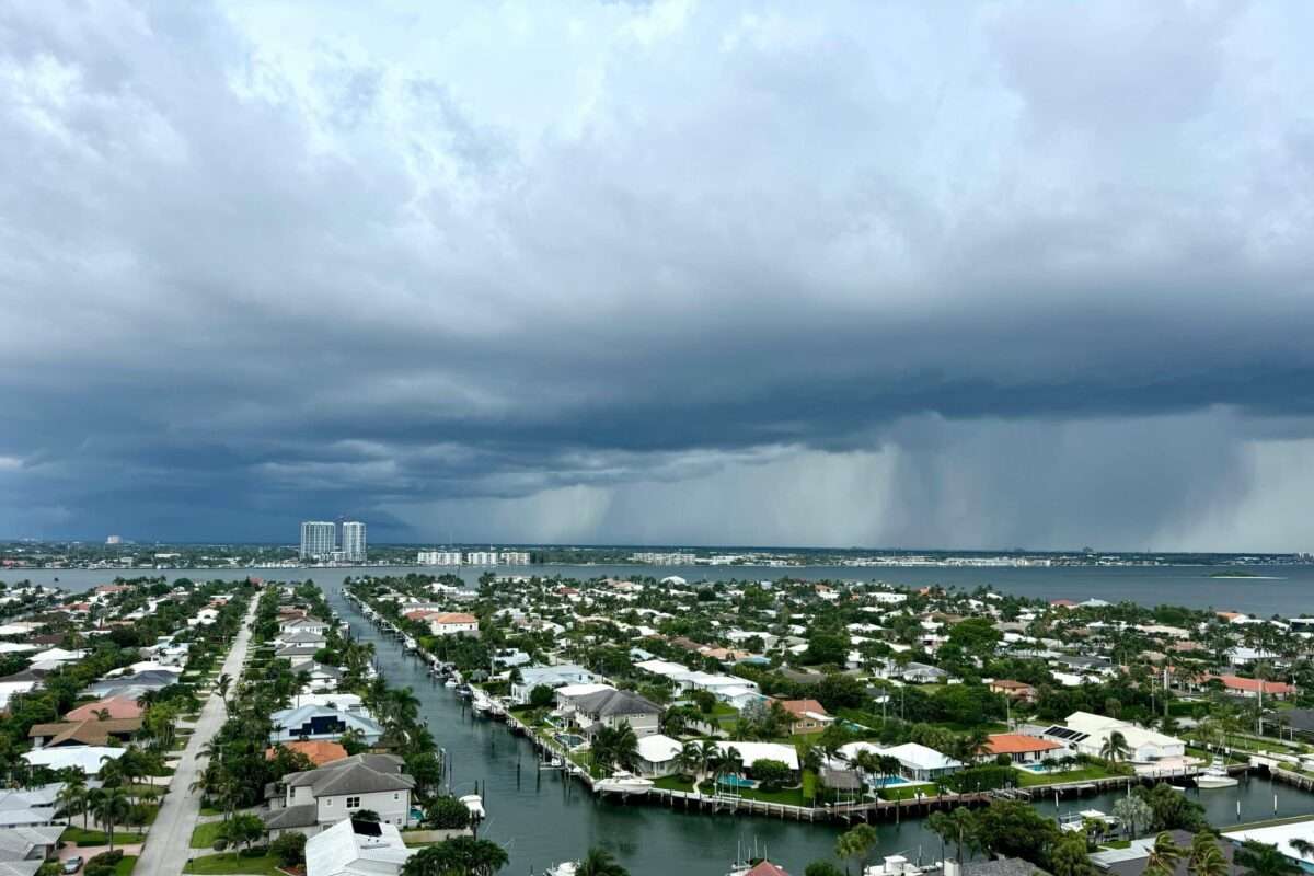 Dark storm clouds gather over a luxury waterfront neighborhood in South Florida, highlighting the importance of hurricane-resistant home construction, resilient engineering, and coastal living.