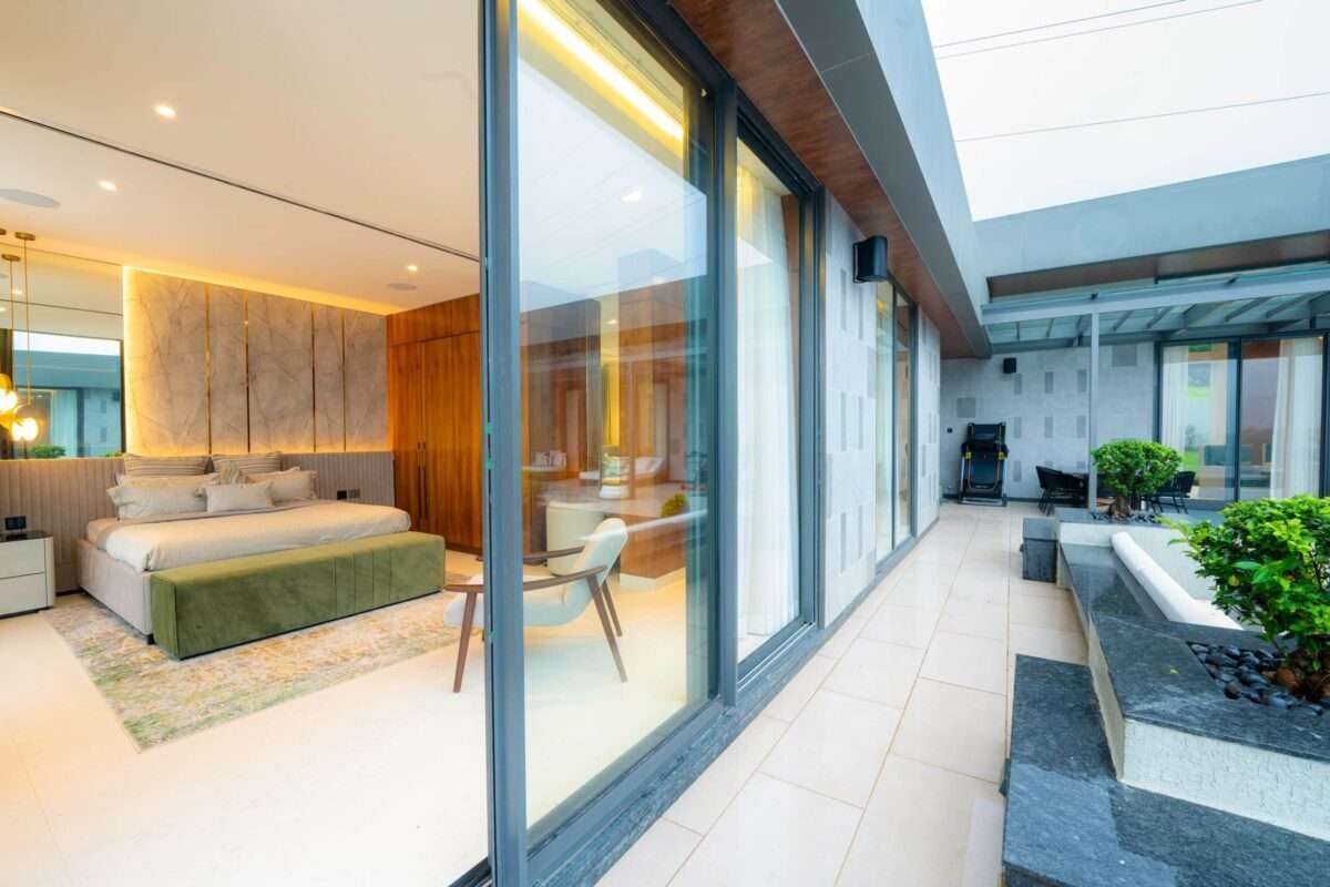 Biophilic architecture in a South Florida luxury home featuring floor-to-ceiling glass, seamless indoor-outdoor living, natural materials, and abundant daylight.