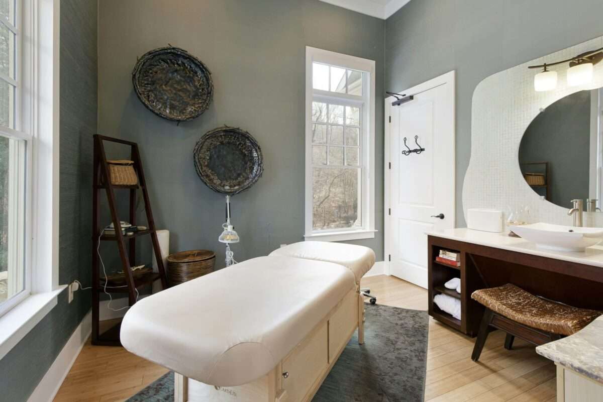 Private luxury home massage and wellness treatment room with professional table and sink