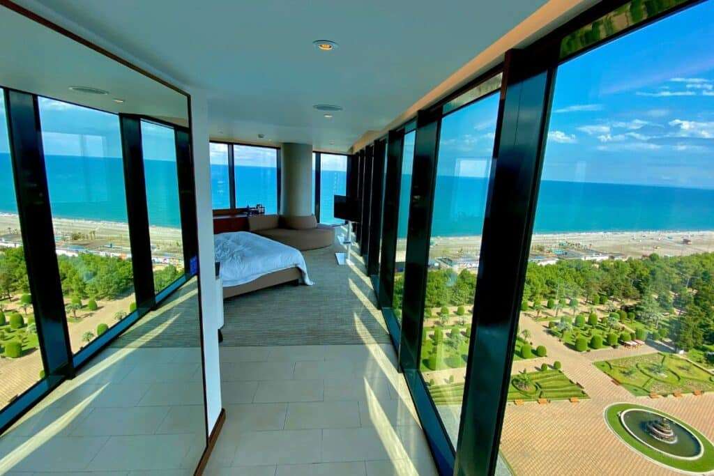 Floor-to-ceiling glass windows in a luxury residence with expansive ocean views