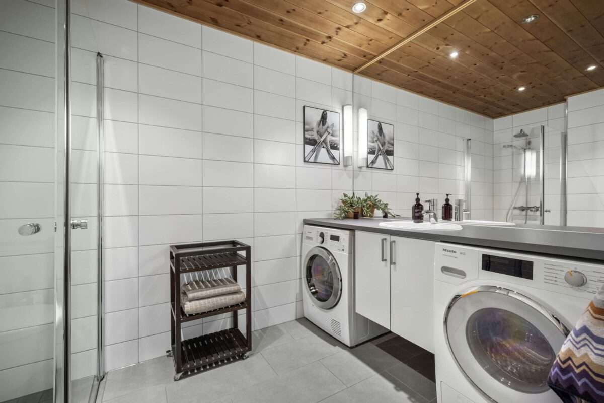 Modern laundry room with front-loading washer and dryer and built-in cabinetry