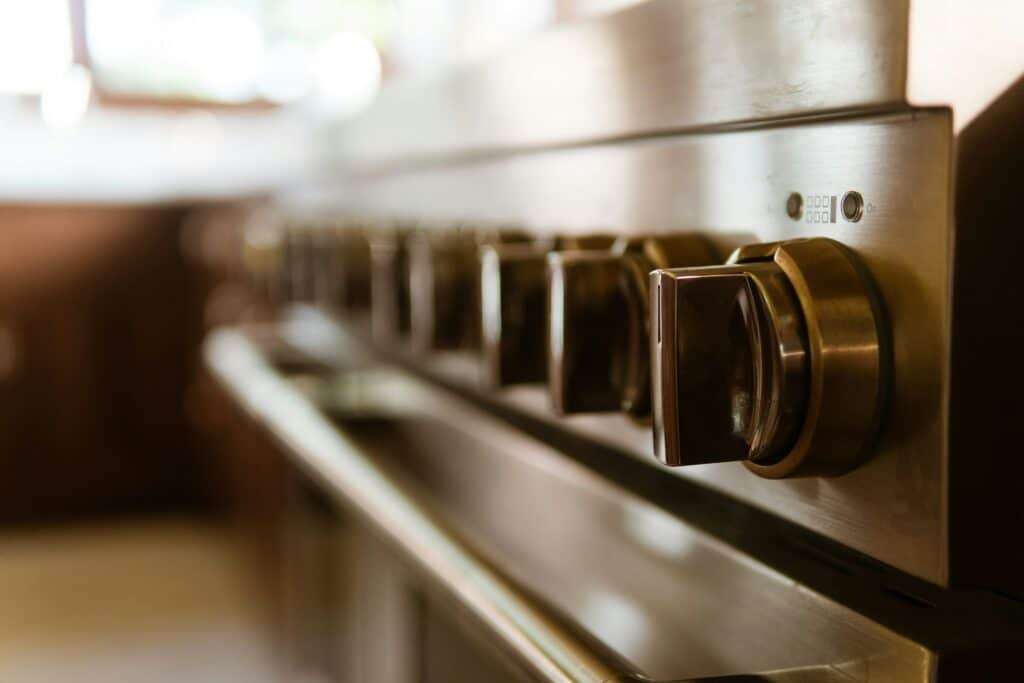 Stainless steel range controls in a South Florida luxury home kitchen